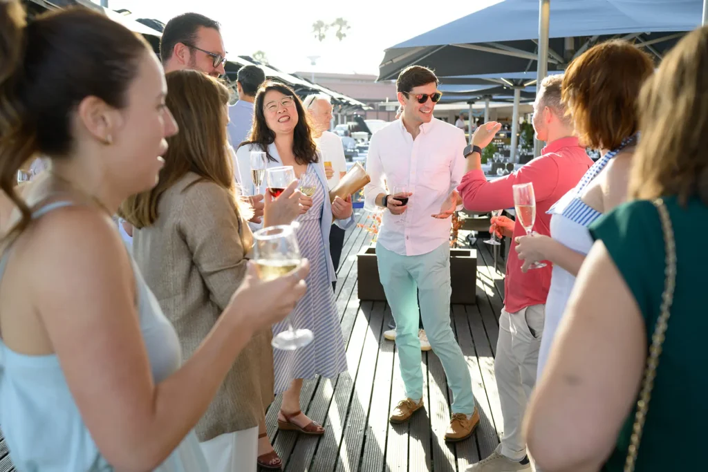 Profissionais B2B em momento de networking durante evento corporativo, fotografia profissional com iluminação natural e composição estratégica